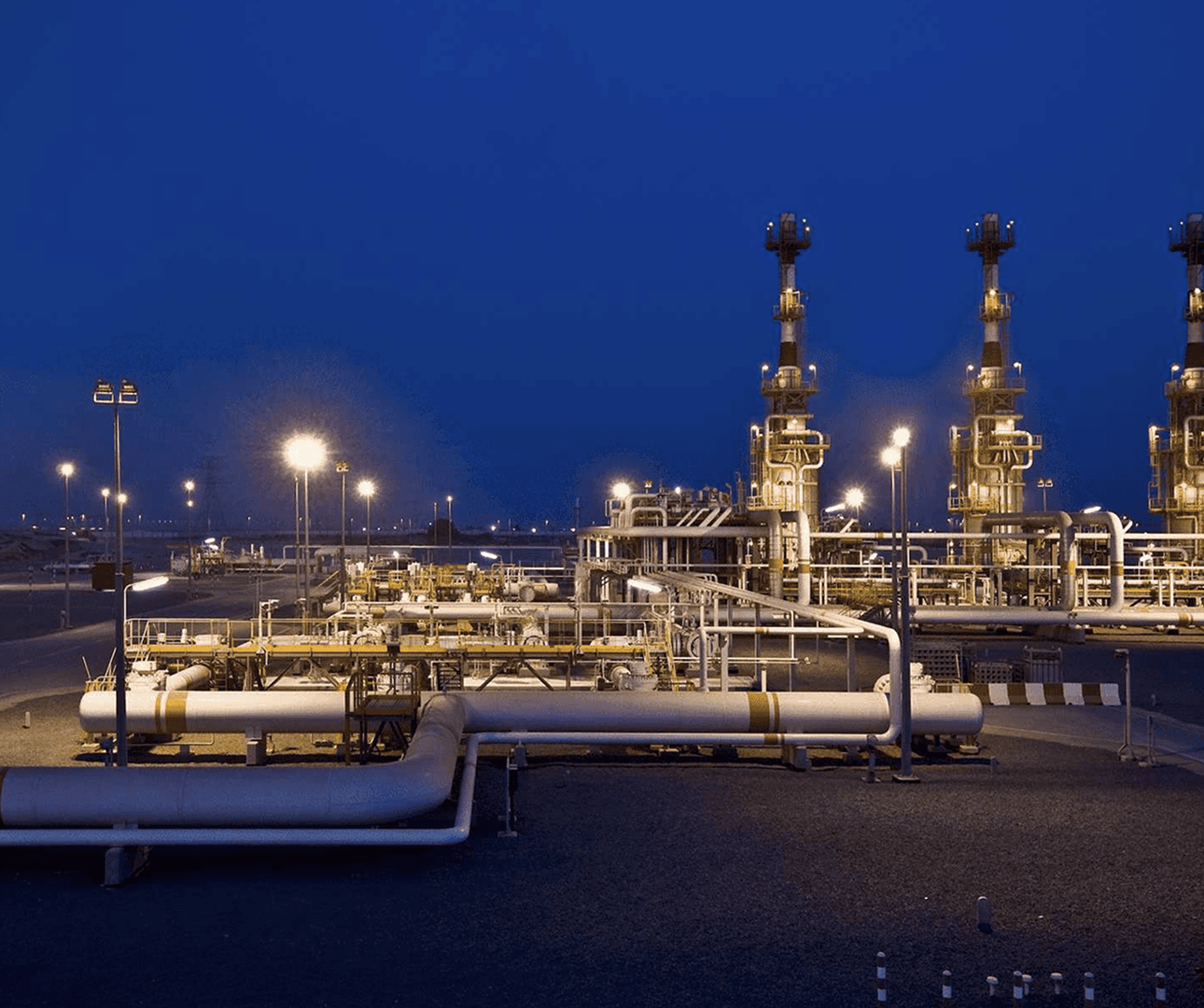 Industrial energy plant illuminated during dusk.