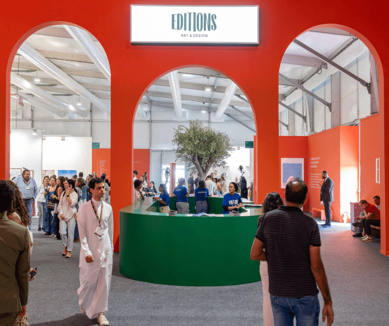 Art exhibition hall with visitors exploring installations.